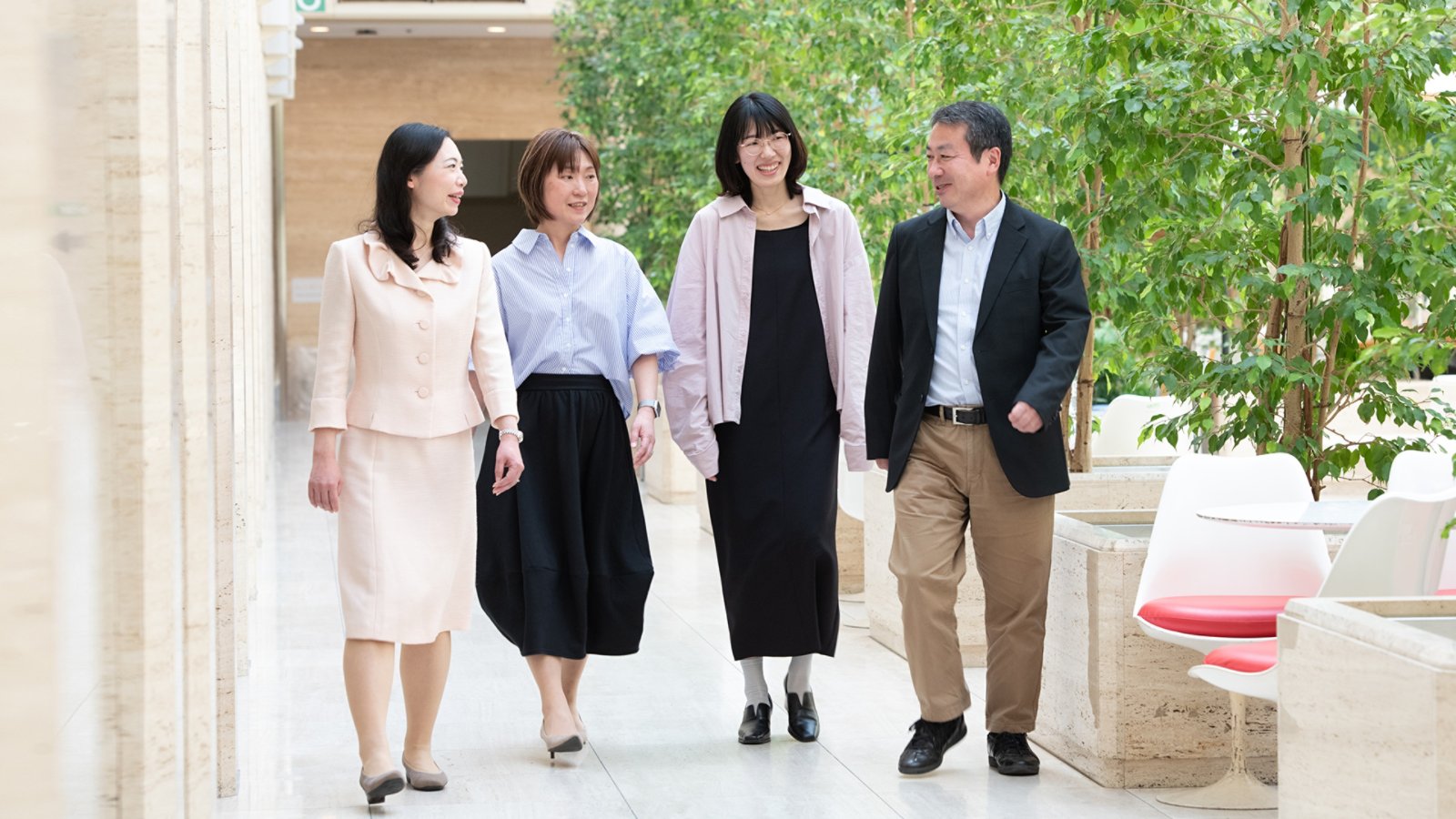 Team of four people walking outside