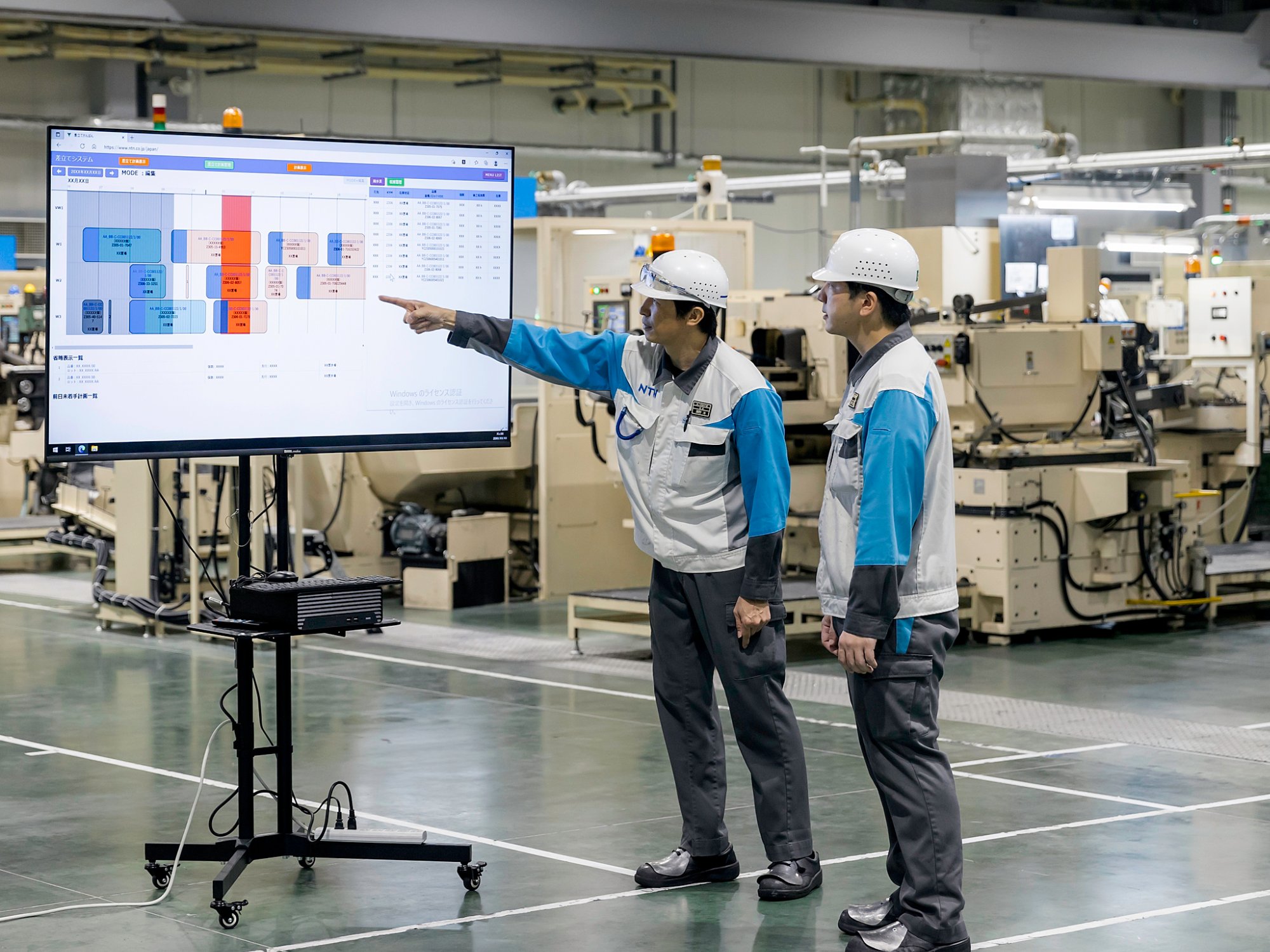 ntn-worker-pointing-to-screen