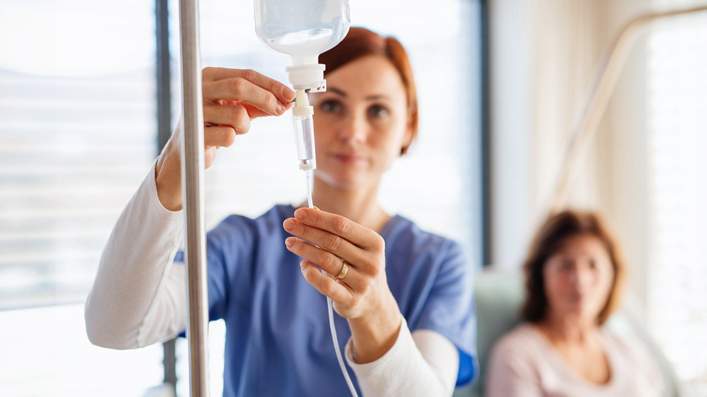 Nurse adjusting IV
