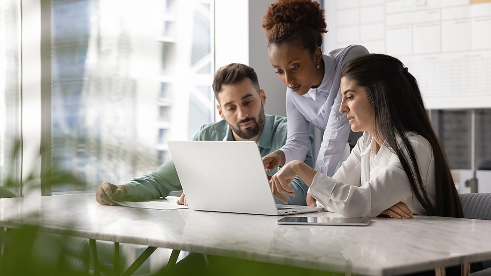office workers around laptop - 2