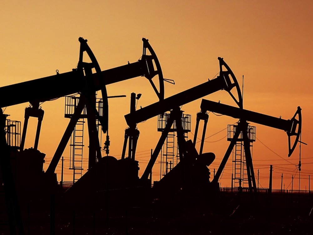 Many oil pumps at sunset under the red sky