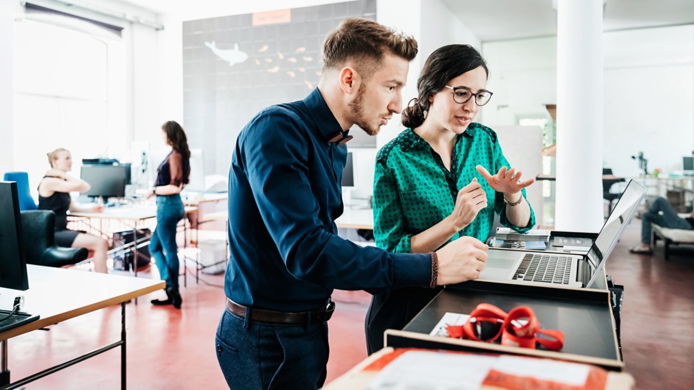 A group of startup business employees working together in a modern office environment.