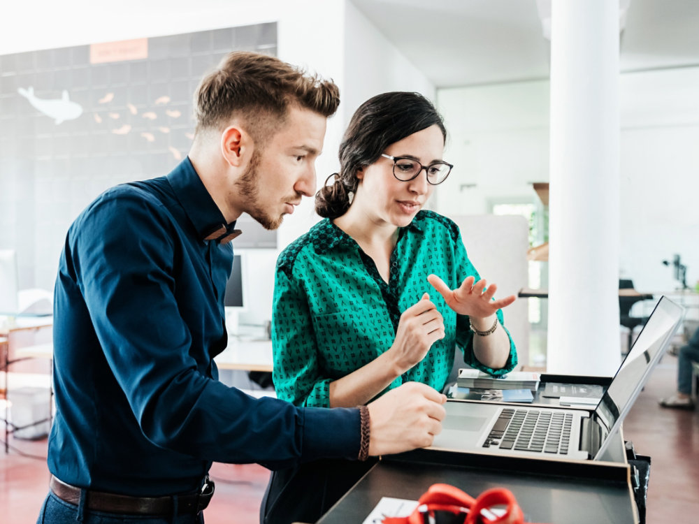 A group of startup business employees working together in a modern office environment.