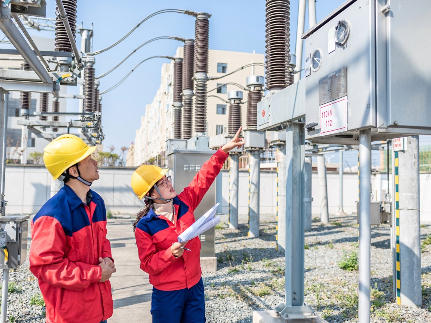 Power engineer checking electrical equipment at substation