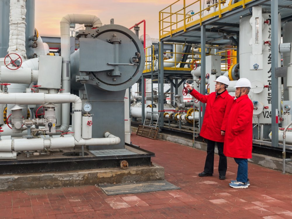 Engineers and staff communicate on site in chemical plant