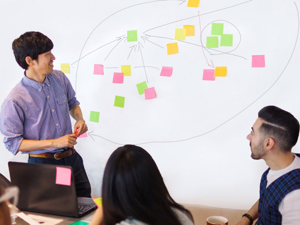 A businessman is giving a presentation in a modern co-working space.