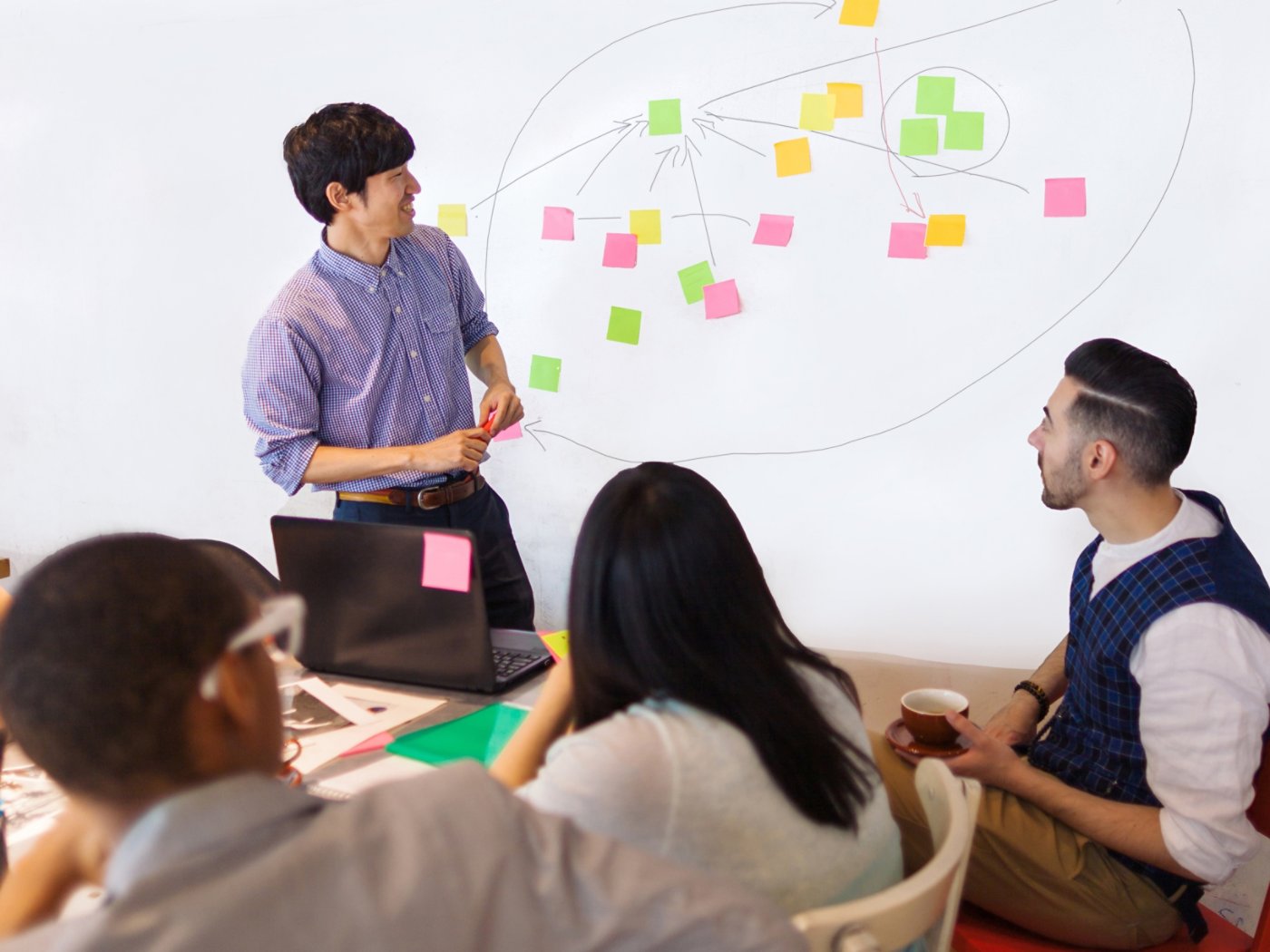 A businessman is giving a presentation in a modern co-working space.