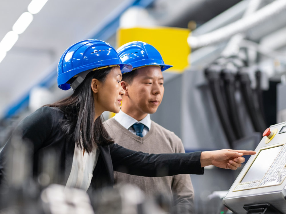 Investor Talking To Engineer And Manager At A Factory