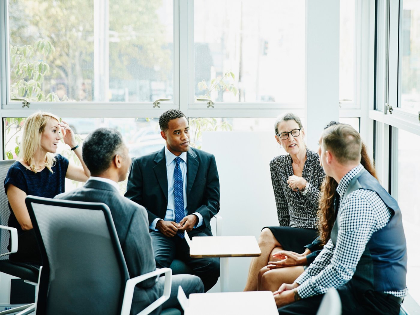 Mature businesswoman leading team meeting in conference room