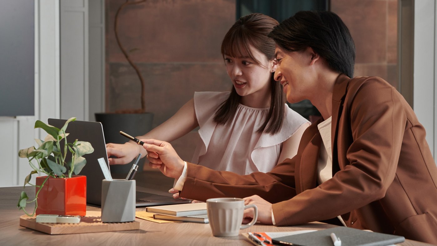 Two people reviewing items