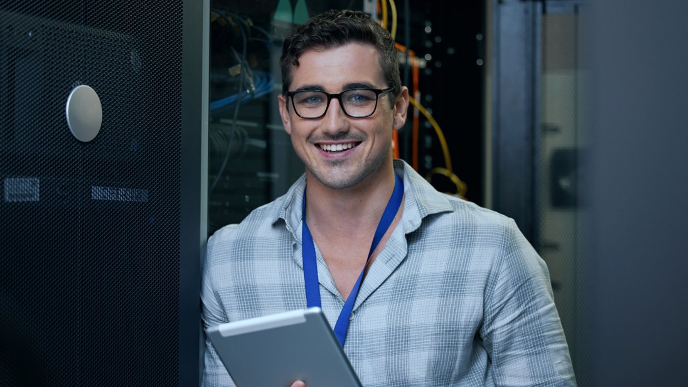 Engineer, server room and portrait of a man with a tablet for programming, cybersecurity or maintenance. Technician person in a datacenter for network, software or system upgrade app with technology.