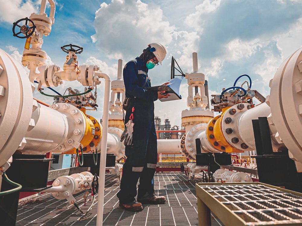 pipeline worker at refinery on sunny day