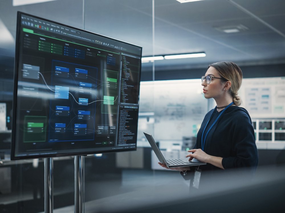 Portrait of a Multiethnic QA Engineer Working on Finding and Fixing Bugs in a Product or Program Software Code Before the Launch. Female Using Laptop Computer, Collaborating with Developers Online