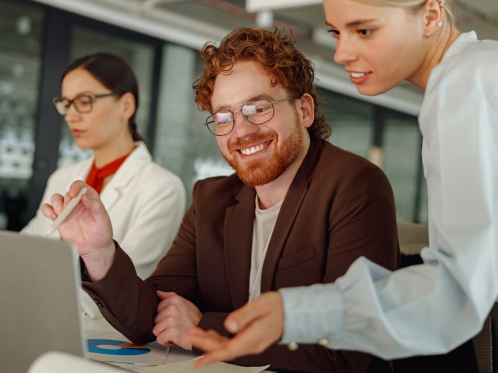 Diverse team members collaborate on an exciting project in a modern workspace, showcasing teamwork and creativity