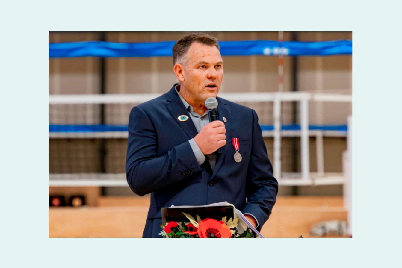 A man is giving speech in front of people