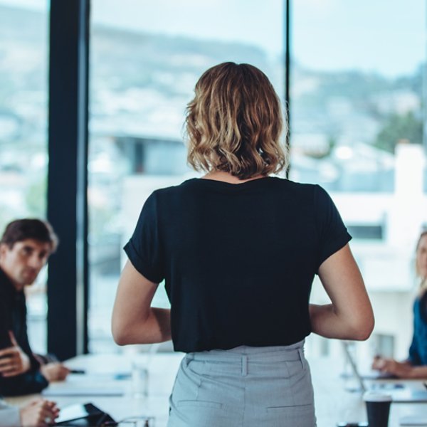 Woman addressing a meeting in office boardroom. Businesswoman having a meeting with her office staff.
