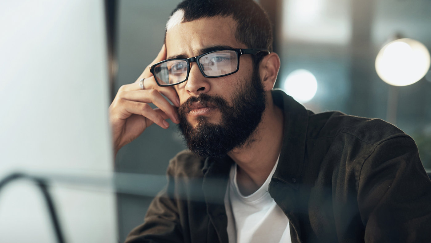 Man looking at computer screen AdobeStock_493402959