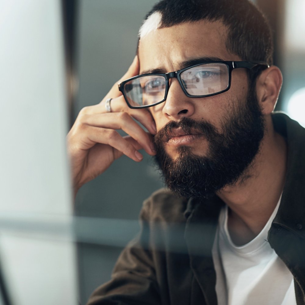 Man looking at computer screen AdobeStock_493402959
