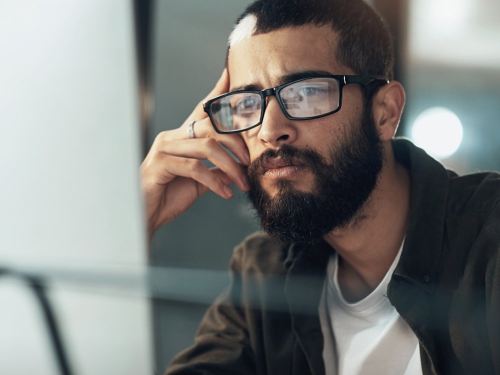 Man looking at computer screen AdobeStock_493402959