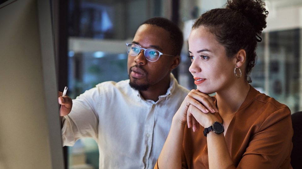 Man and woman working on computer