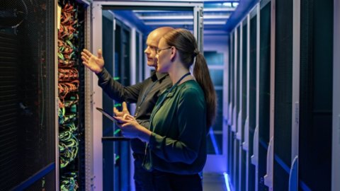 Man and woman working at a data center