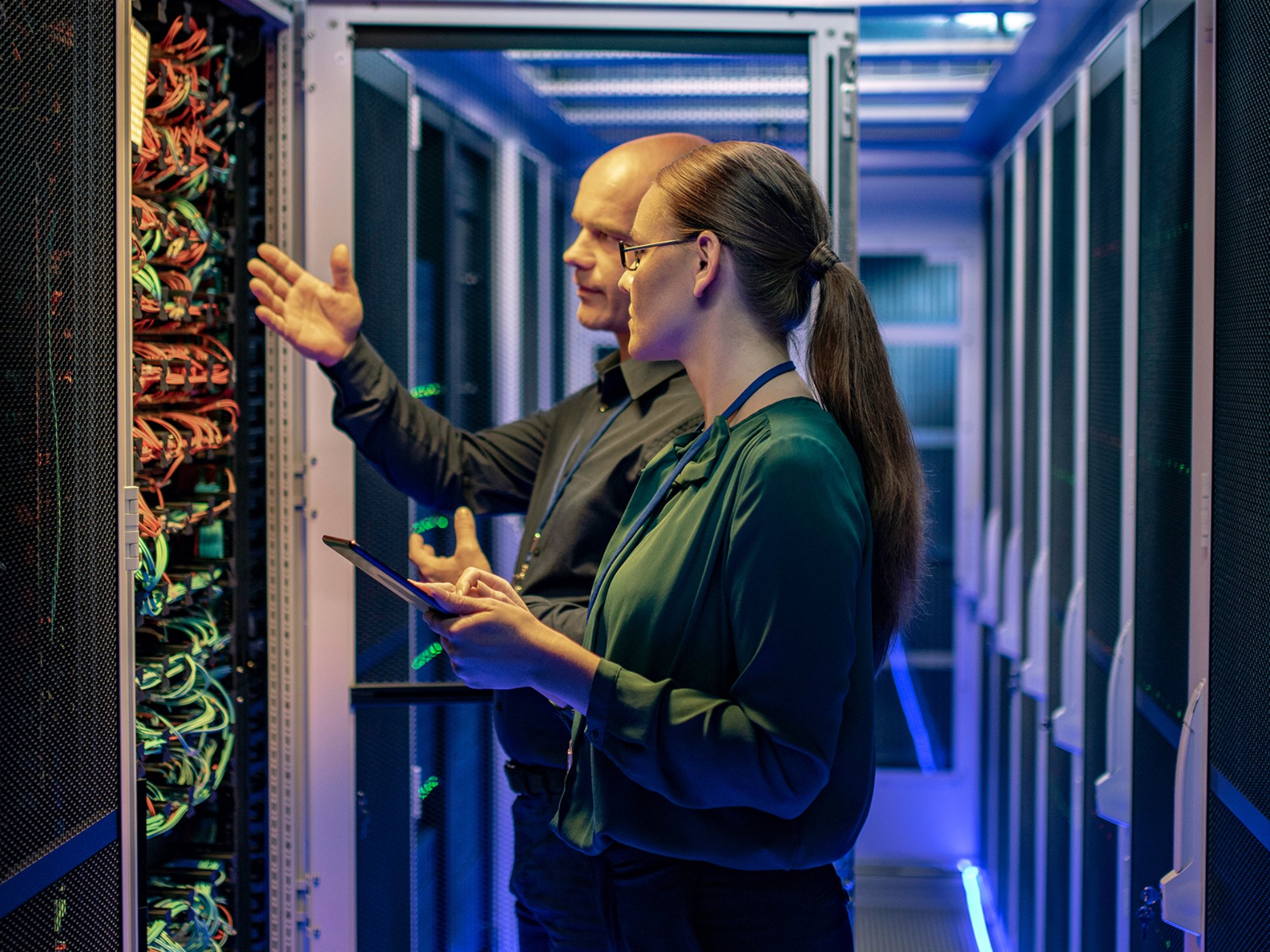 Man and woman working at a data center