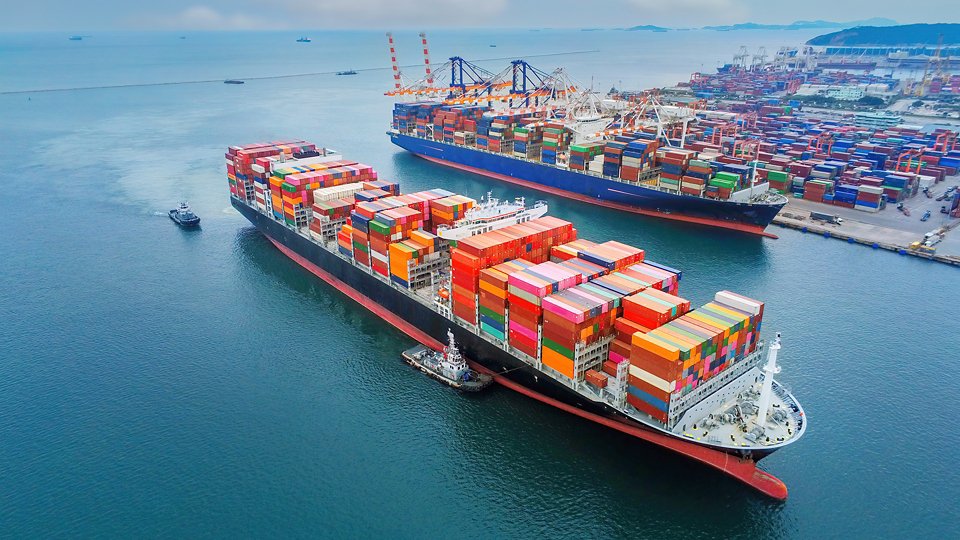 cargo ship and truck at seaport waiting for container dock crane shipment harbor loading container import and export commercial trade business logistic and transportation international. 