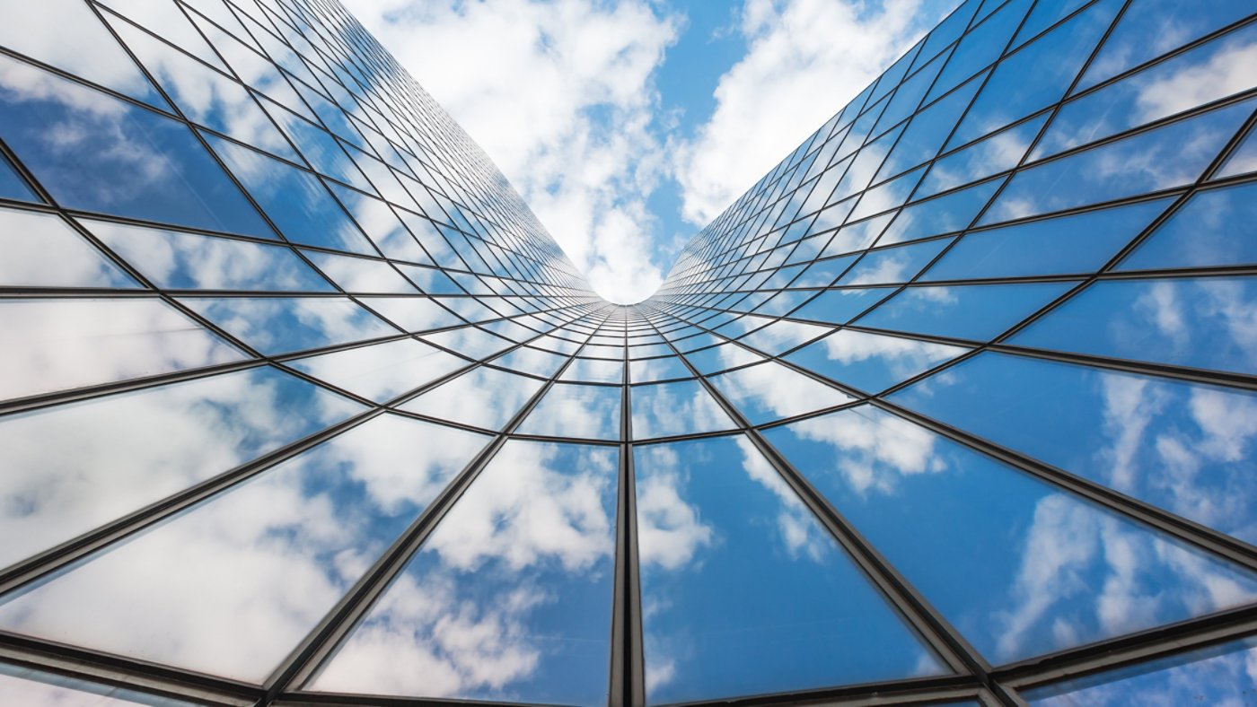 blue sky reflected in glass building