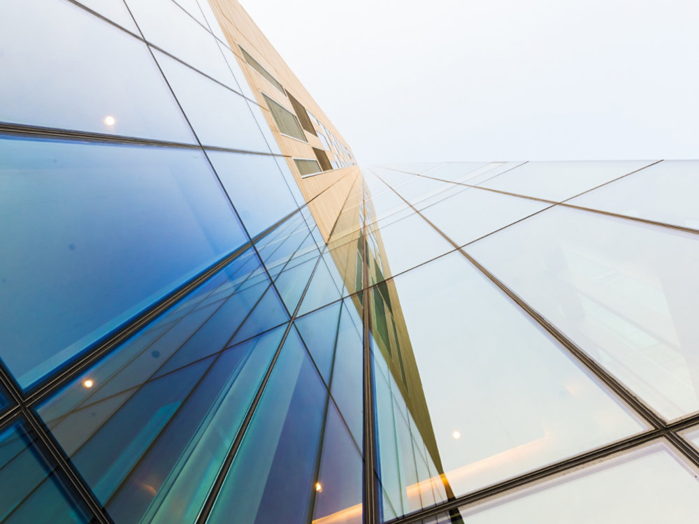 Glass modern building against bright sky