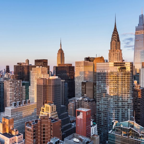 This high angle sunrise view from UN Plaza on the east side of Manhattan looks southwest over the Kips Bay neighborhood toward the Empire State Building, the Chrysler Building, and One Vanderbilt with Lower Manhattan and One World Trade Center in the distance.