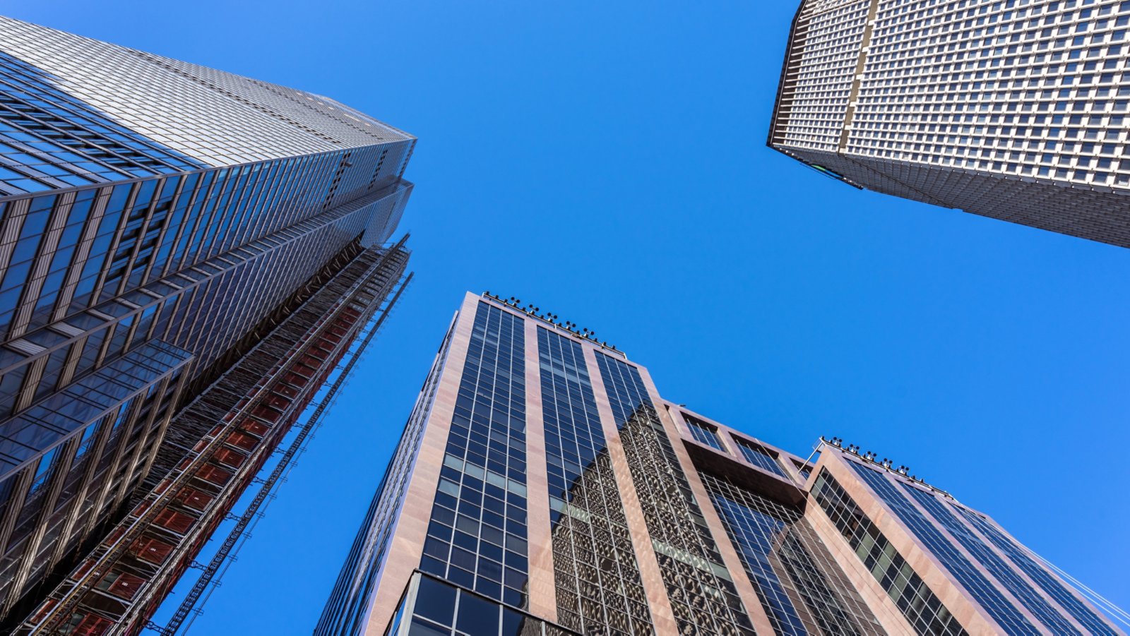 This view from Vanderbilt Avenue in Midtown Manhattan looks up at the tall office buildings along the avenue near Grand Central Terminal.  Among the buildings seen here are the under construction One Vanderbilt and the MetLife Building (formerly the PanAm Building).
