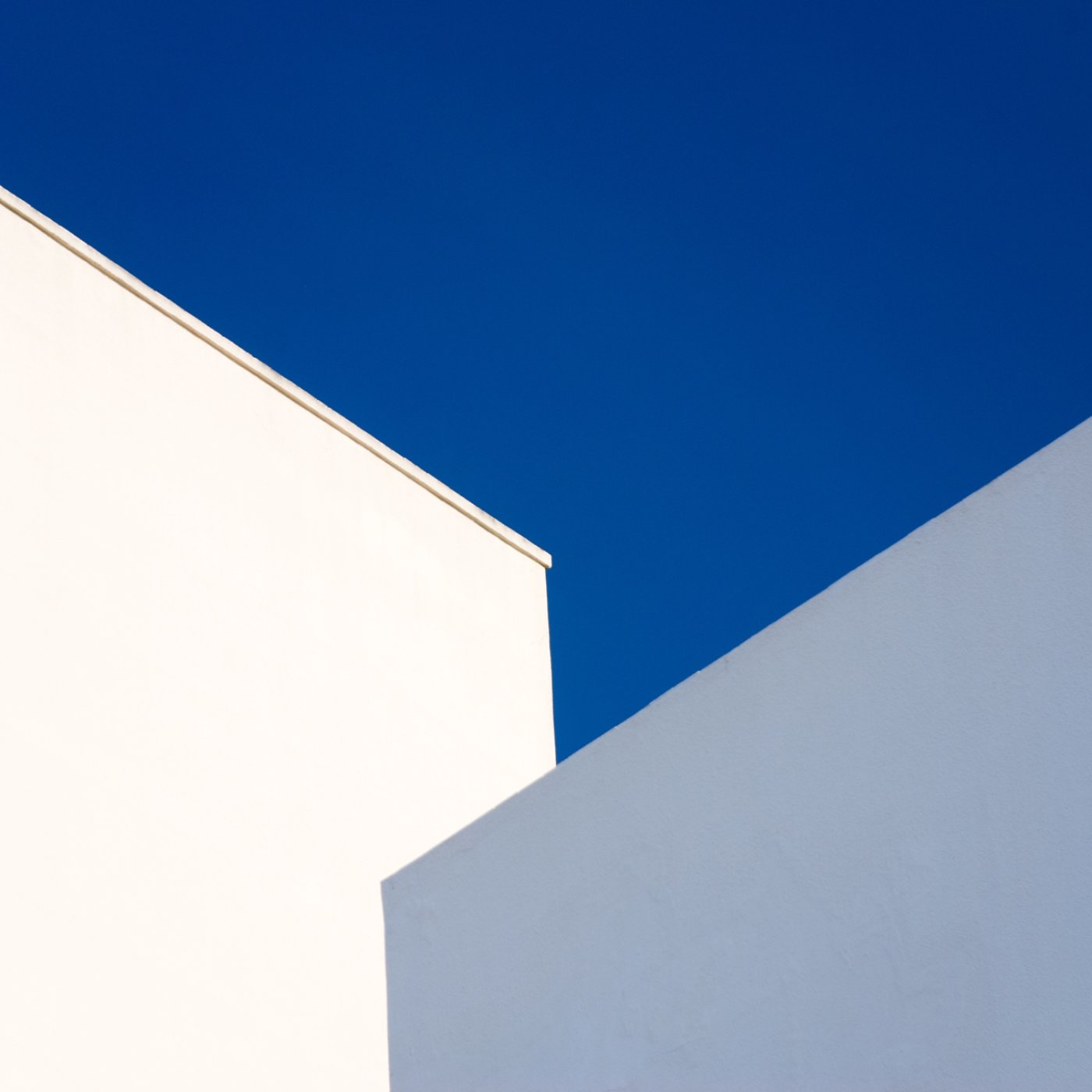 Walls of a white and pale blue buildings against a vibrant blue sky, Cadiz, Andalucia, Spain, Europe.