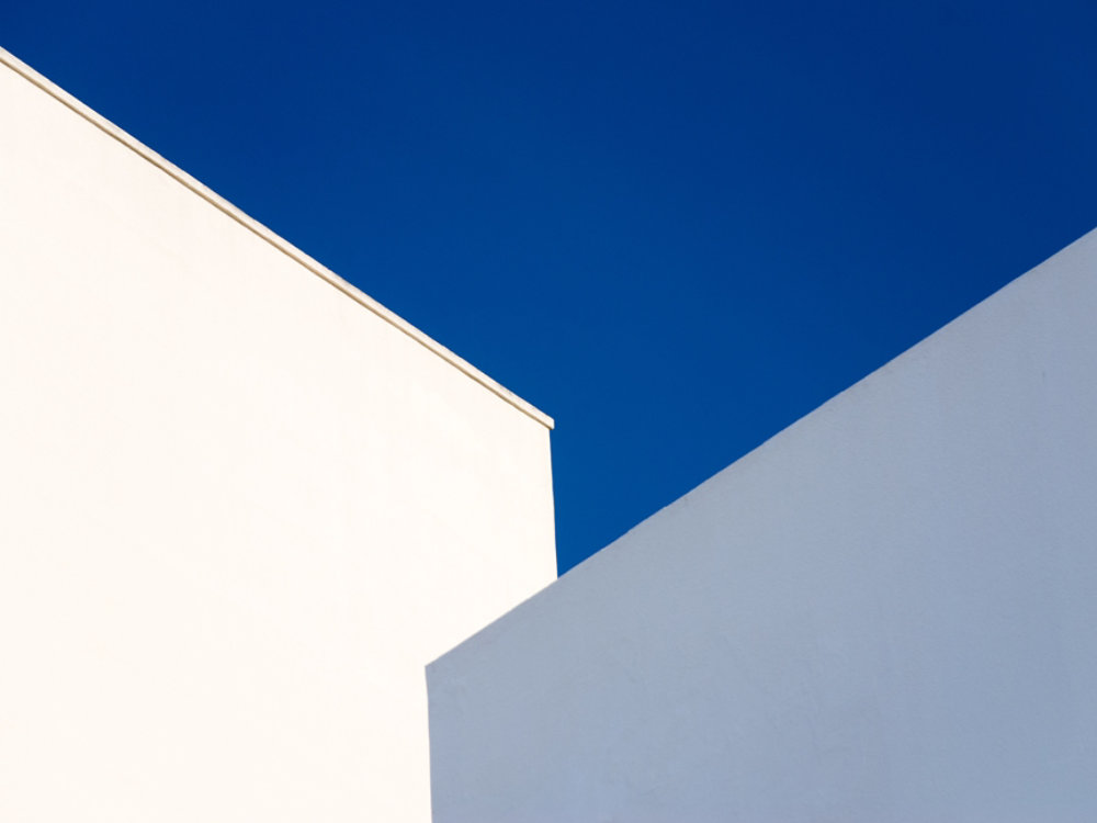 Walls of a white and pale blue buildings against a vibrant blue sky, Cadiz, Andalucia, Spain, Europe.