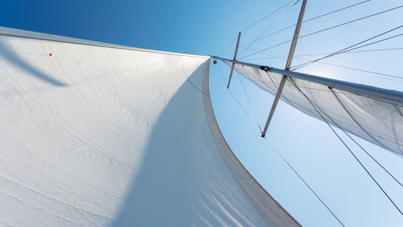 white sails against the blue sky