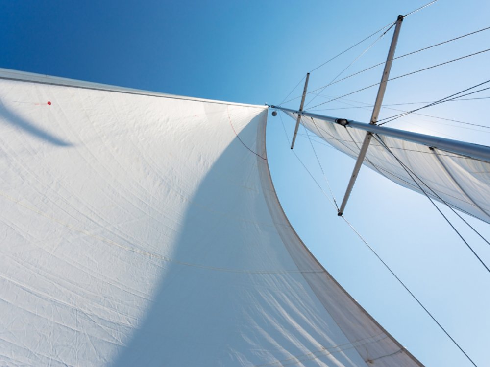 white sails against the blue sky