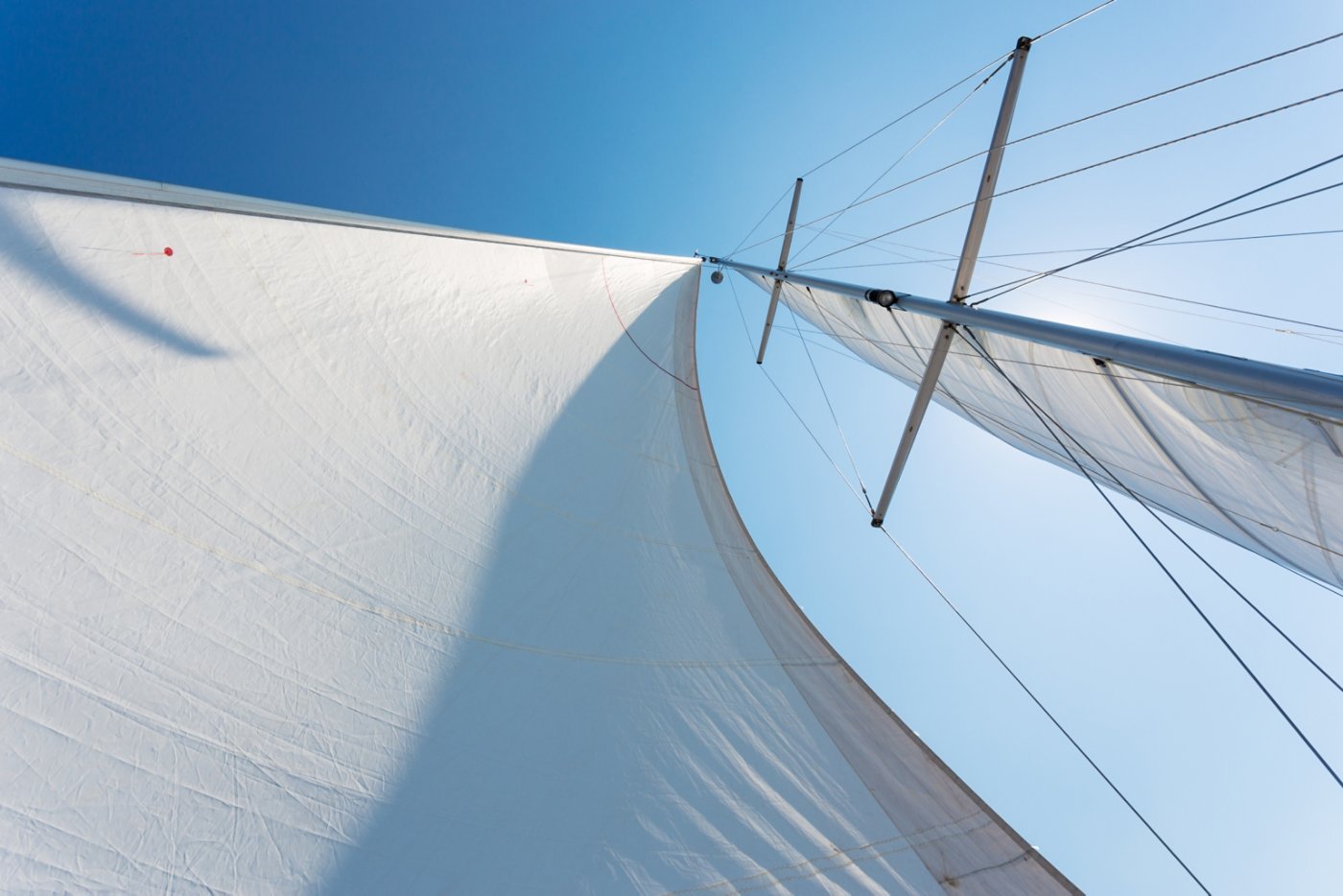 white sails against the blue sky