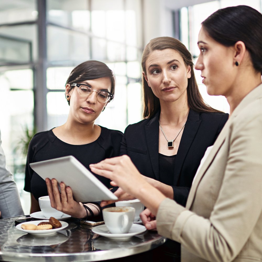 Business, people and communication with tablet in office for collaboration or partnership on company project for growth strategy. Team, diversity and digital technology for daily feedback or review