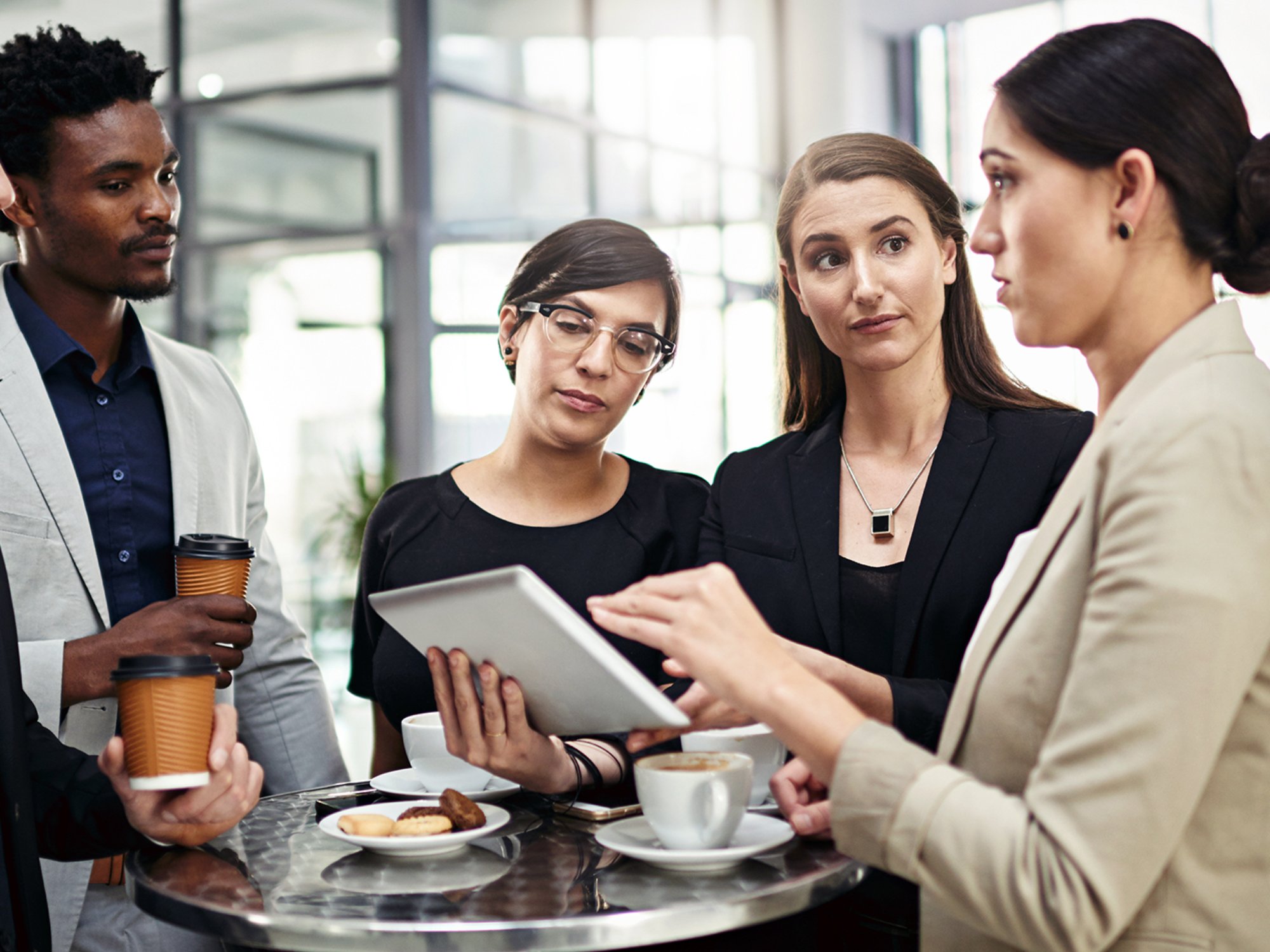 Business, people and communication with tablet in office for collaboration or partnership on company project for growth strategy. Team, diversity and digital technology for daily feedback or review