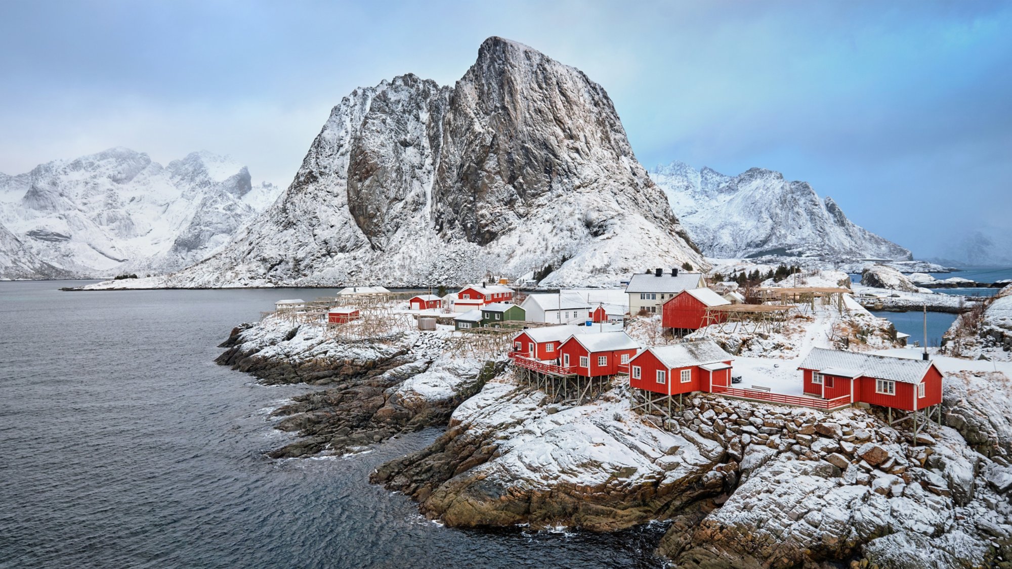 Panorama of famous tourist attraction Hamnoy fishing village on Lofoten Islands, Norway with red rorbu houses in winter