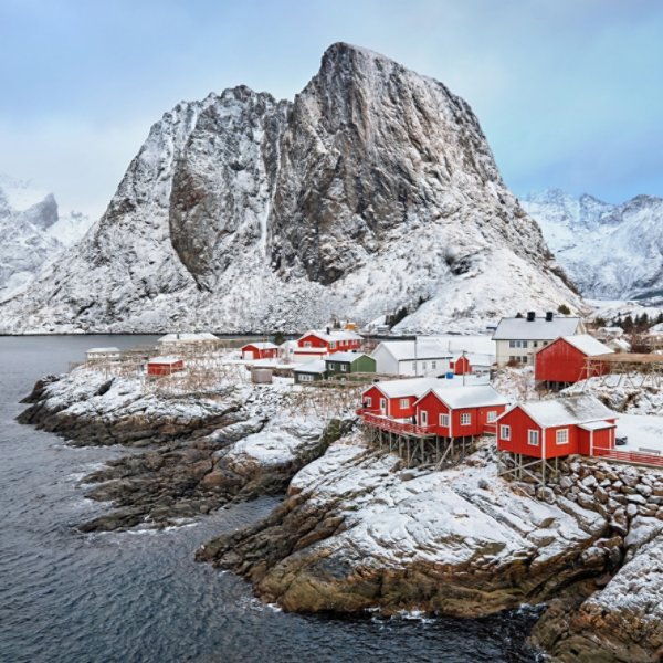 Panorama of famous tourist attraction Hamnoy fishing village on Lofoten Islands, Norway with red rorbu houses in winter