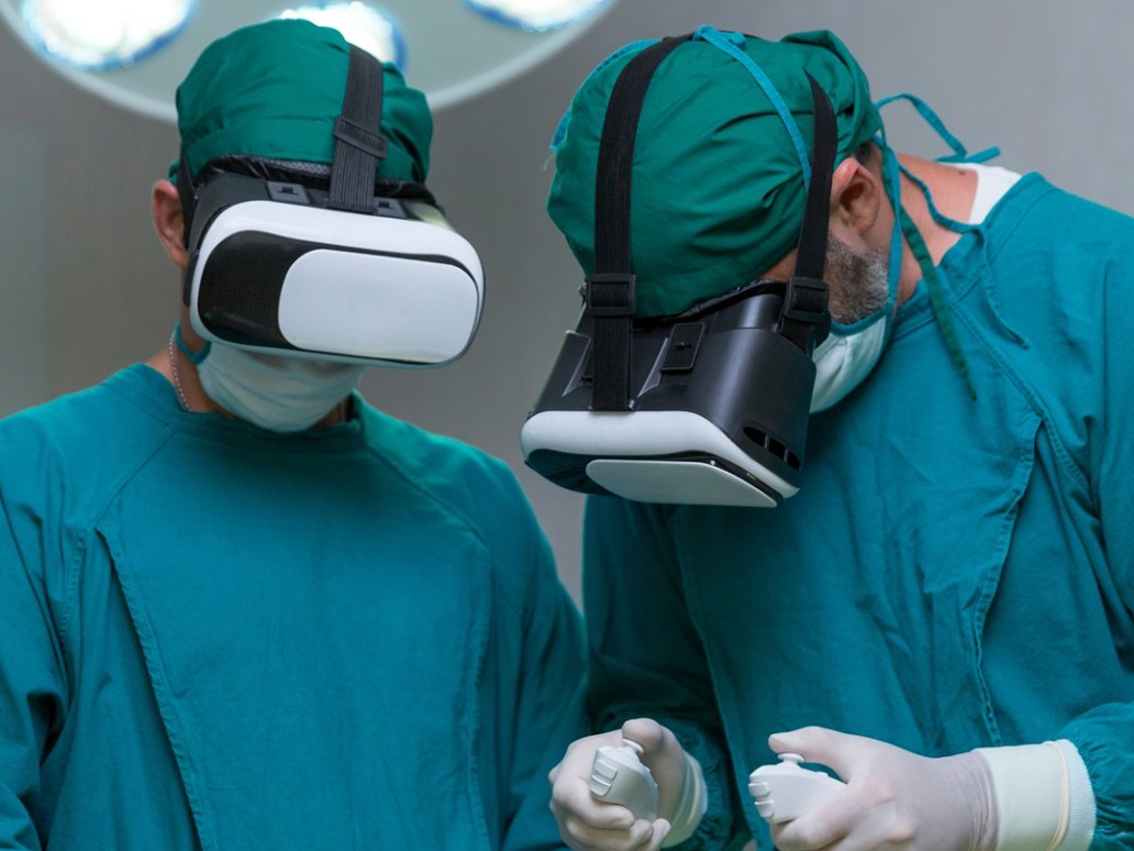 Doctor surgeon wearing virtual reality glasses. The surgeon is doing surgery by inserting a camera and using a VR controller.