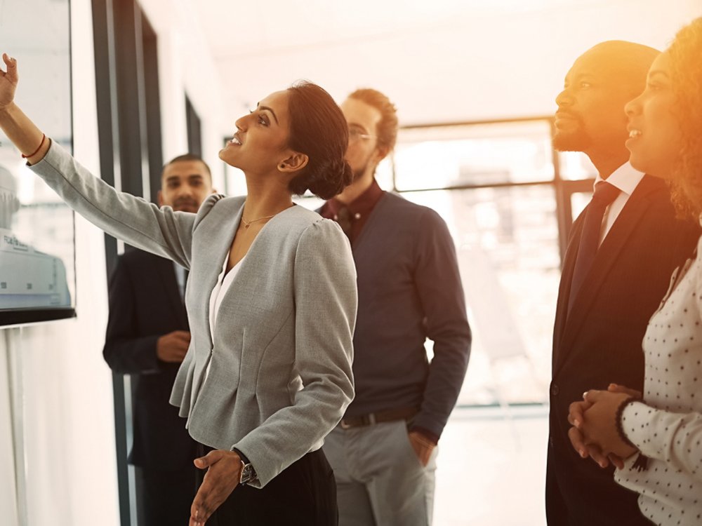 Presentation, strategy and meeting with business people in office for project management, coaching and teamwork. Chart, data and speaker with woman in workshop for training, analytics and planning.