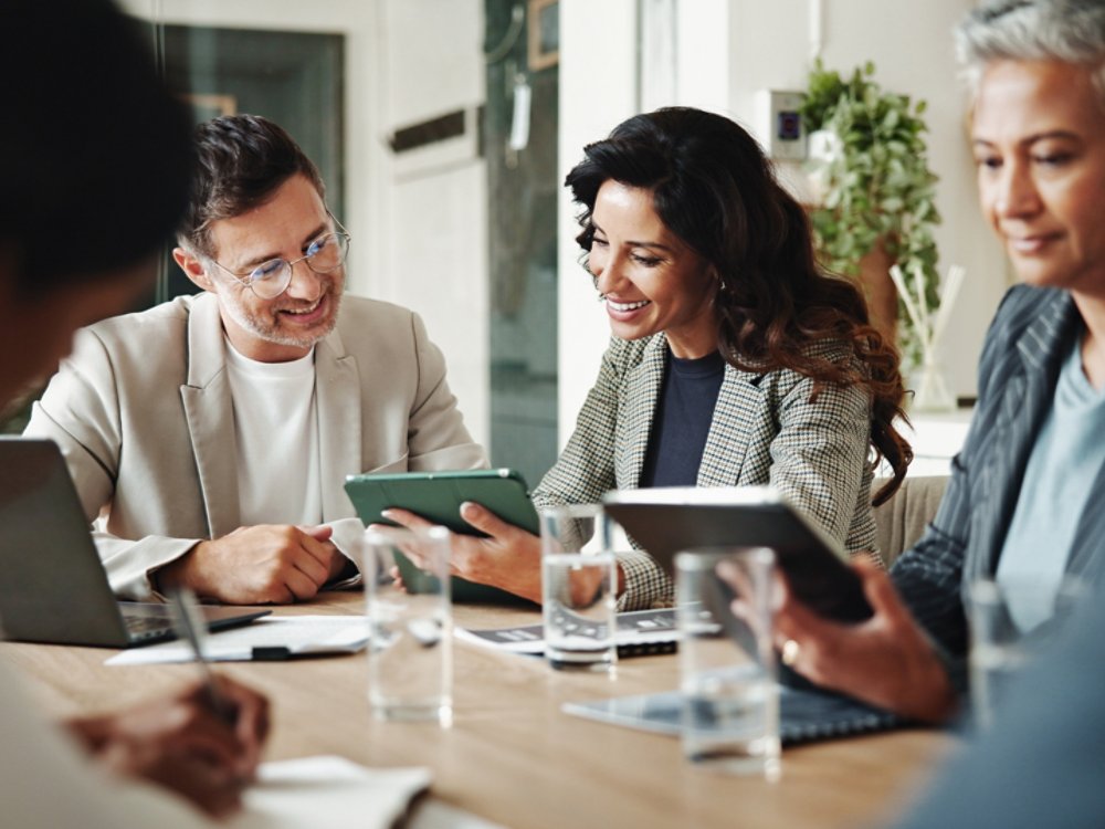 Meeting, technology and business people in office for finance investment with company with online. Collaboration, discussion and financial management team with profit or revenue margin report