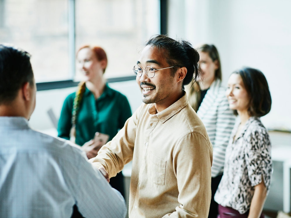 Businessman shaking hands with colleague after meeting in office