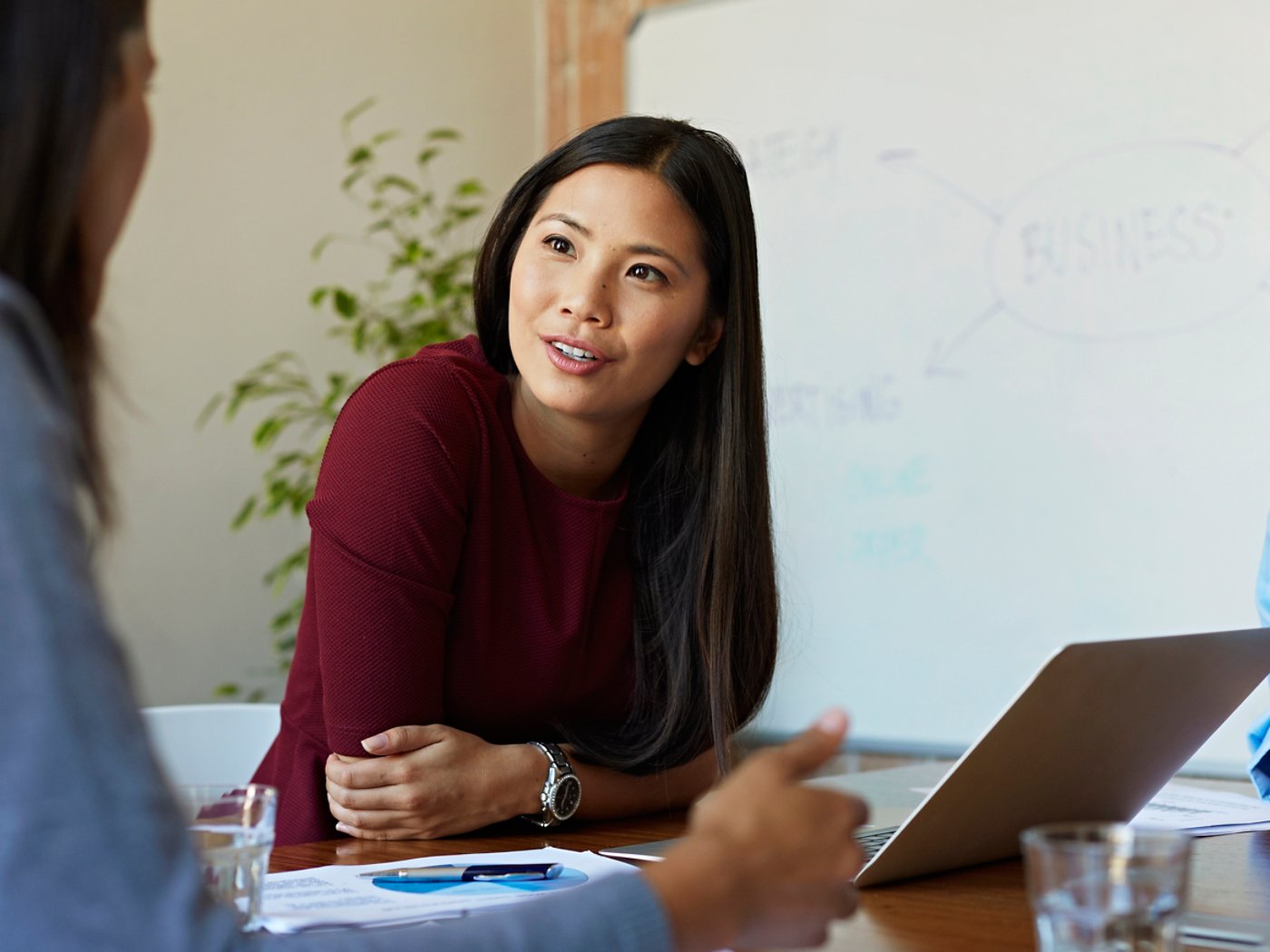 Business women discussing project at table in modern office