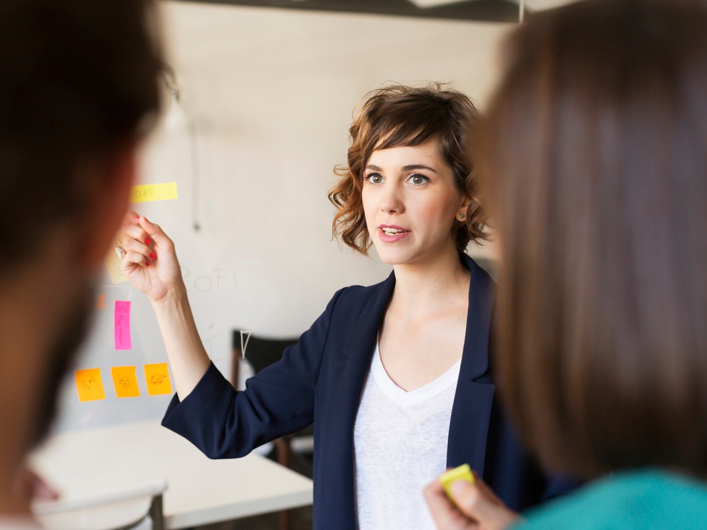 Businesswoman explaining presentation to colleagues in office