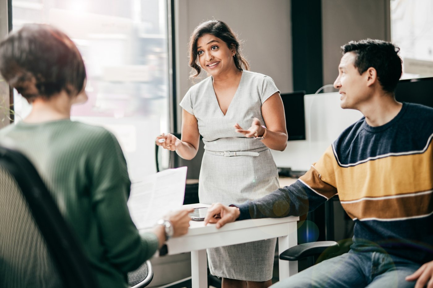 Financial advisor with the clients in her office, Multiracial group discussing new mortgage application