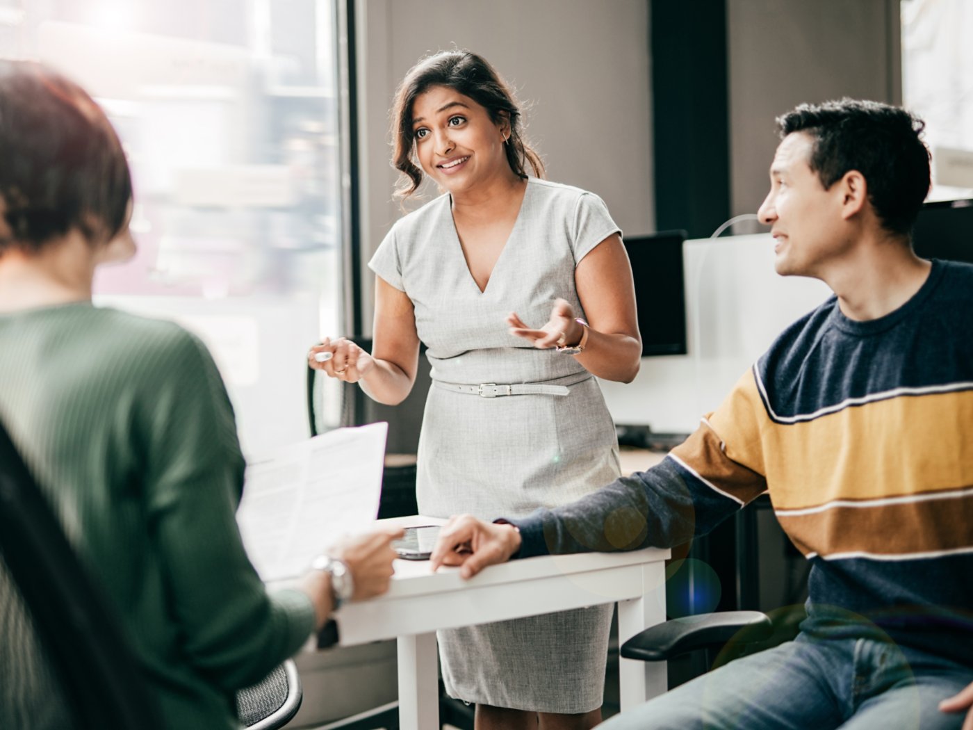 Financial advisor with the clients in her office, Multiracial group discussing new mortgage application