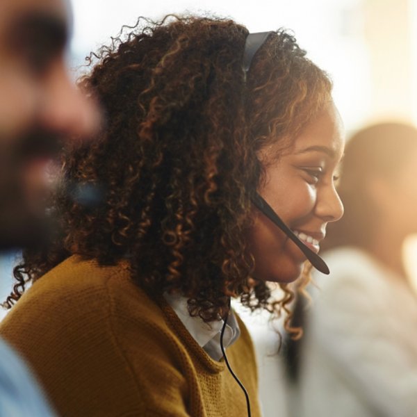 Coworking, contact us or happy woman in call center consulting, speaking or talking at customer services. Virtual assistant, friendly or sales consultant in telemarketing or telecom company help desk.