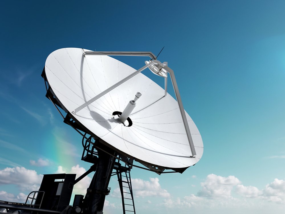 Big parabolic antenna with lens flare sun against sky